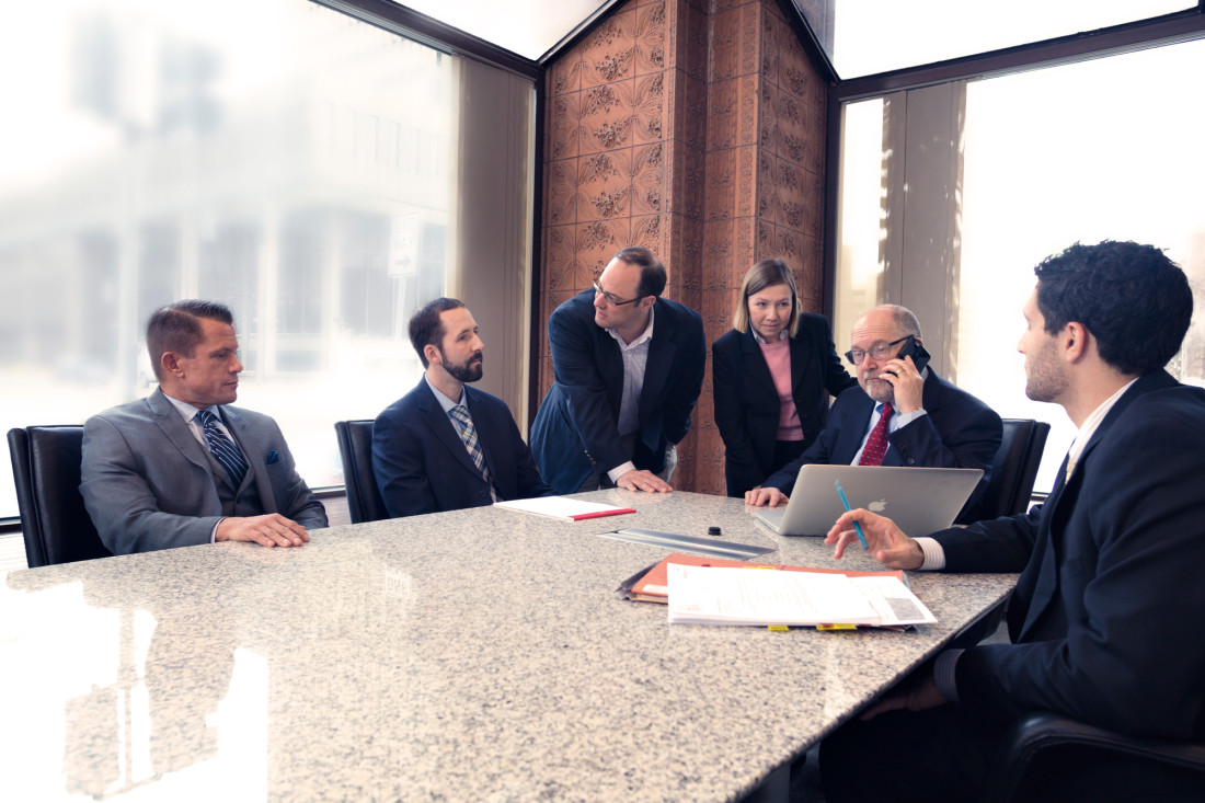 attorneys gathered at conference table