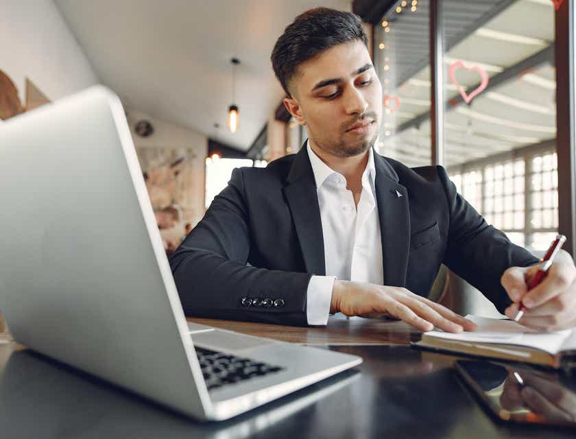 Man in suit sitting at laptop computer