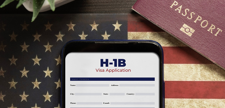 H-1B Visa application on phone. Includes American flag and passport book on table