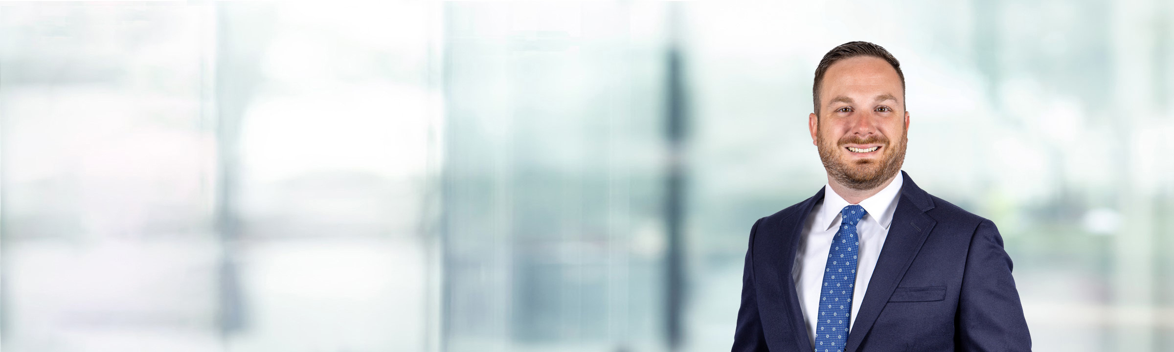 Bryan Carlo on light blue and white bokeh banner