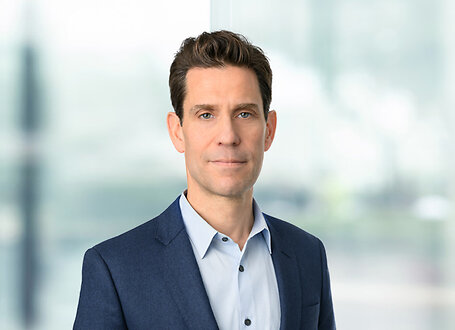 Axel Bernabe on light blue and white bokeh banner