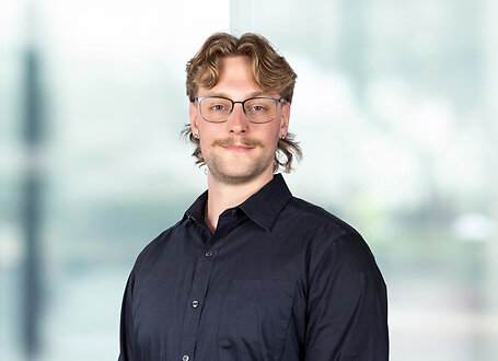 Jake Przybylski on light blue and white bokeh banner