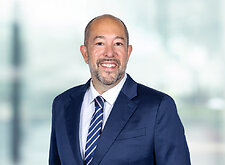 Andrew Freedman on light blue and white bokeh banner