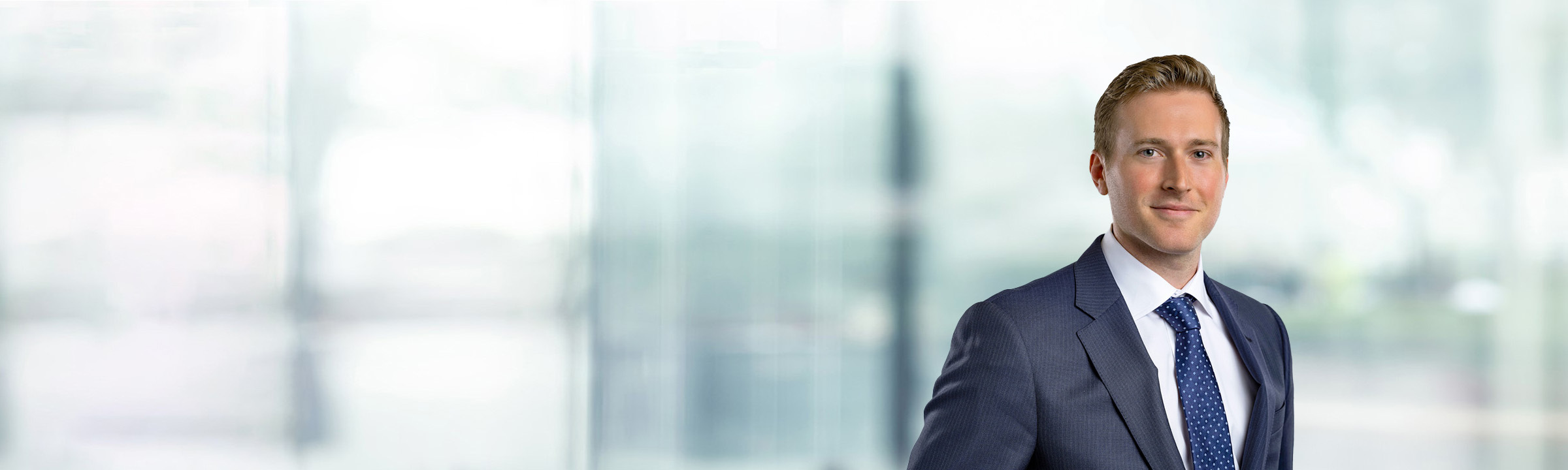 Tanner Shaw on light blue and white bokeh banner