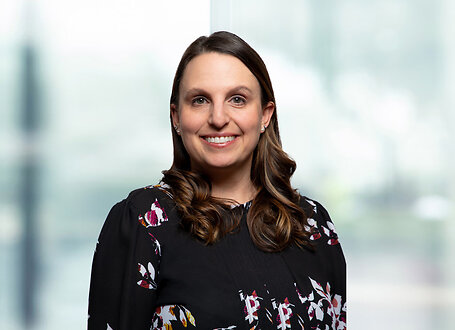 Erin Young on light blue and white bokeh banner