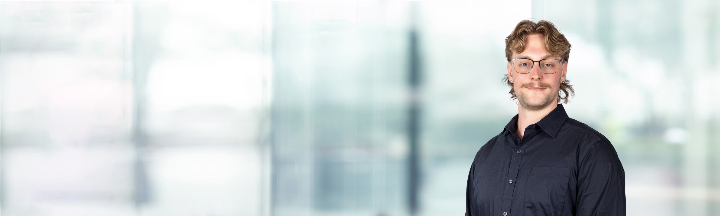 Jake Przybylski on light blue and white bokeh banner