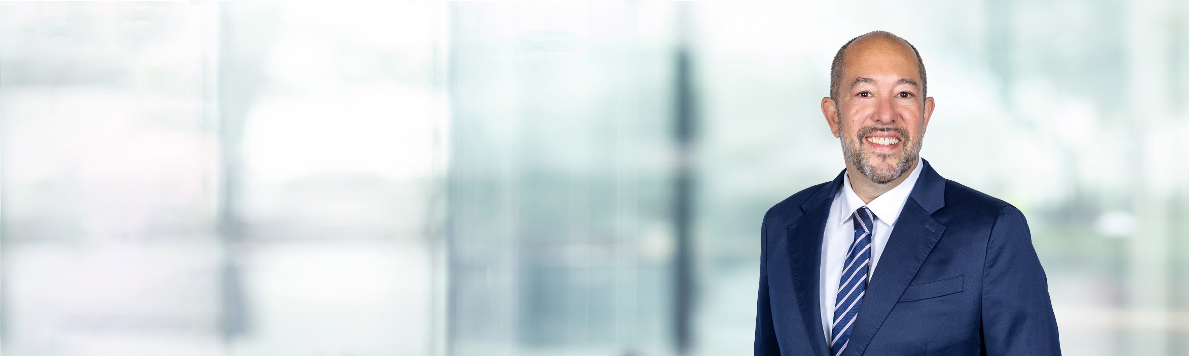 Andrew Freedman on light blue and white bokeh banner