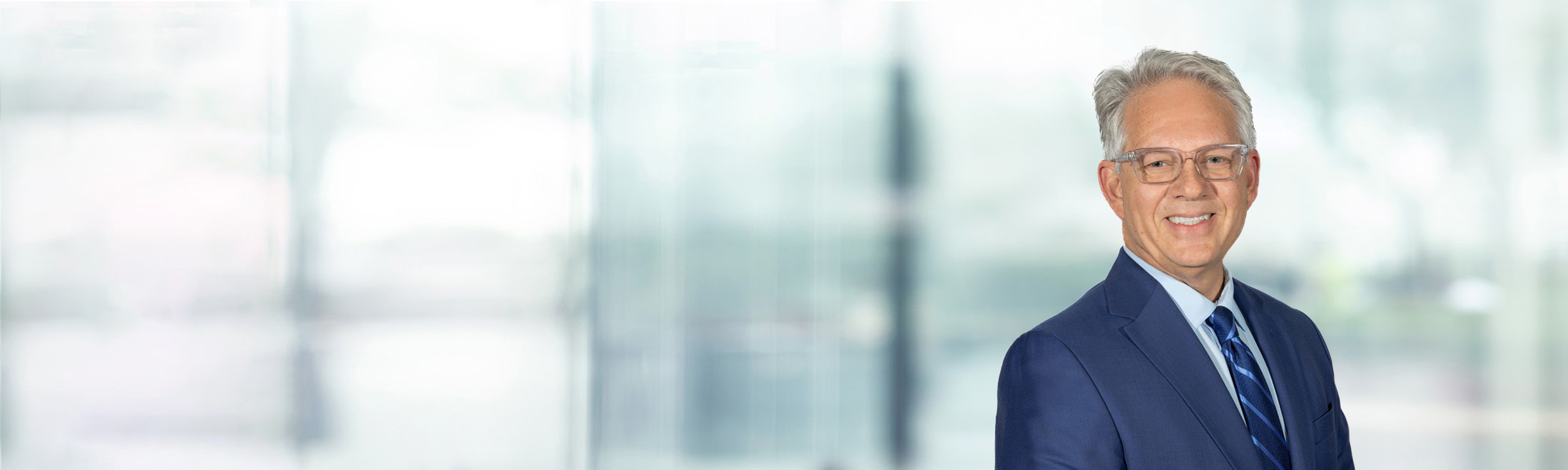 Frank Sarratori on light blue and white bokeh banner