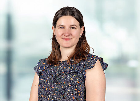 Molly Goonan on light blue and white bokeh banner