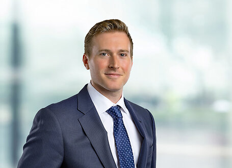 Tanner Shaw on light blue and white bokeh banner