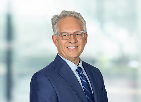 Frank Sarratori on light blue and white bokeh banner