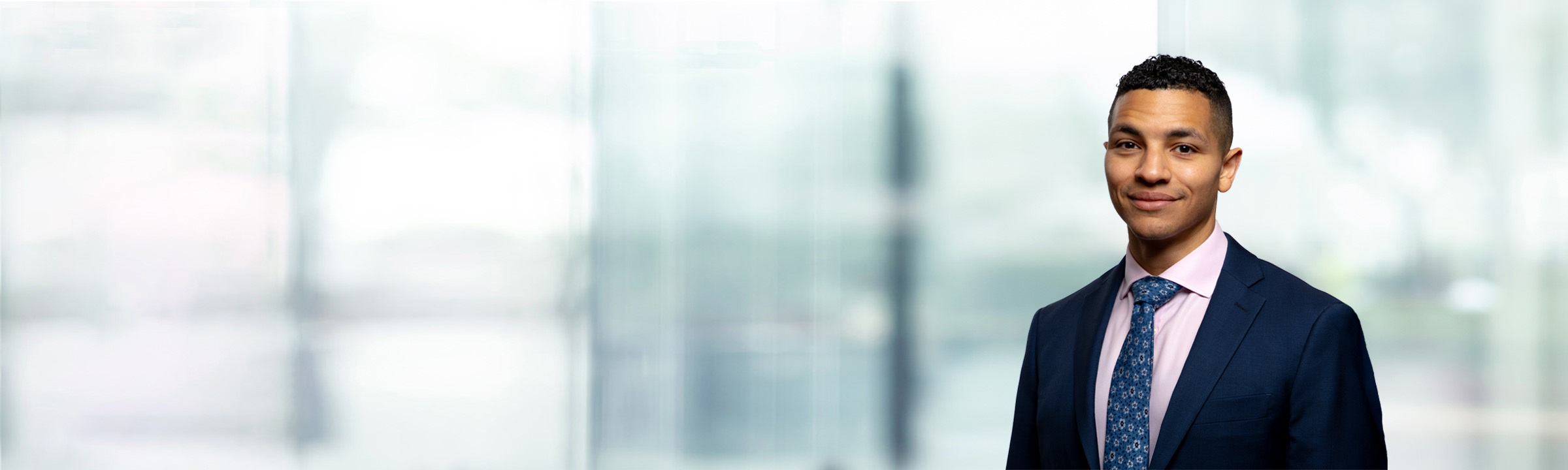 Corben Green on light blue and white bokeh banner