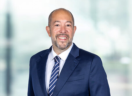 Andrew Freedman on light blue and white bokeh banner