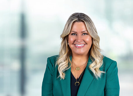 Britta McKenna on light blue and white bokeh banner