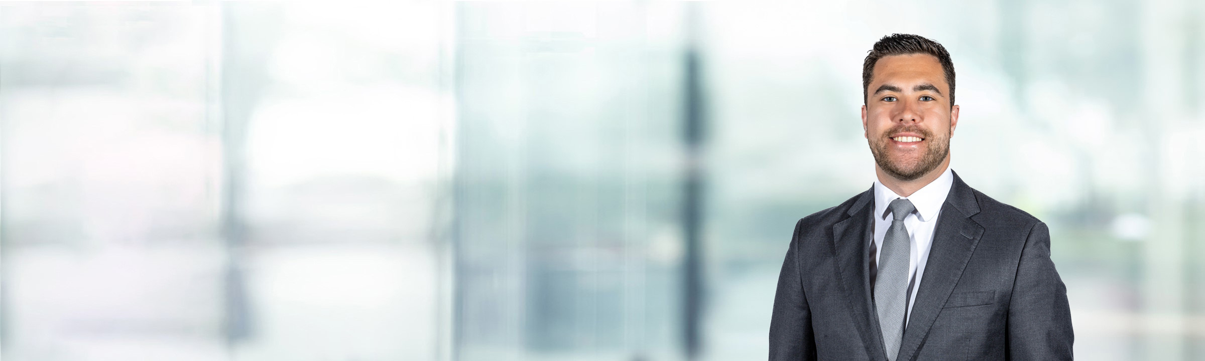 Mario Caito on light blue and white bokeh banner