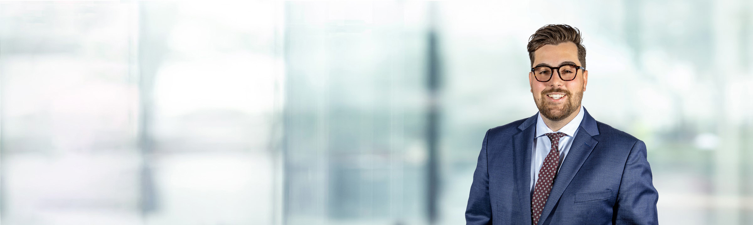 Brandon Bourg on light blue and white bokeh banner