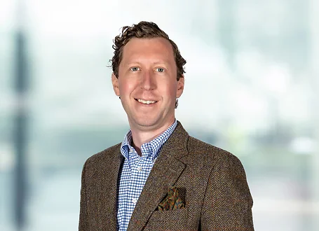 William Ciszewski on light blue and white bokeh banner