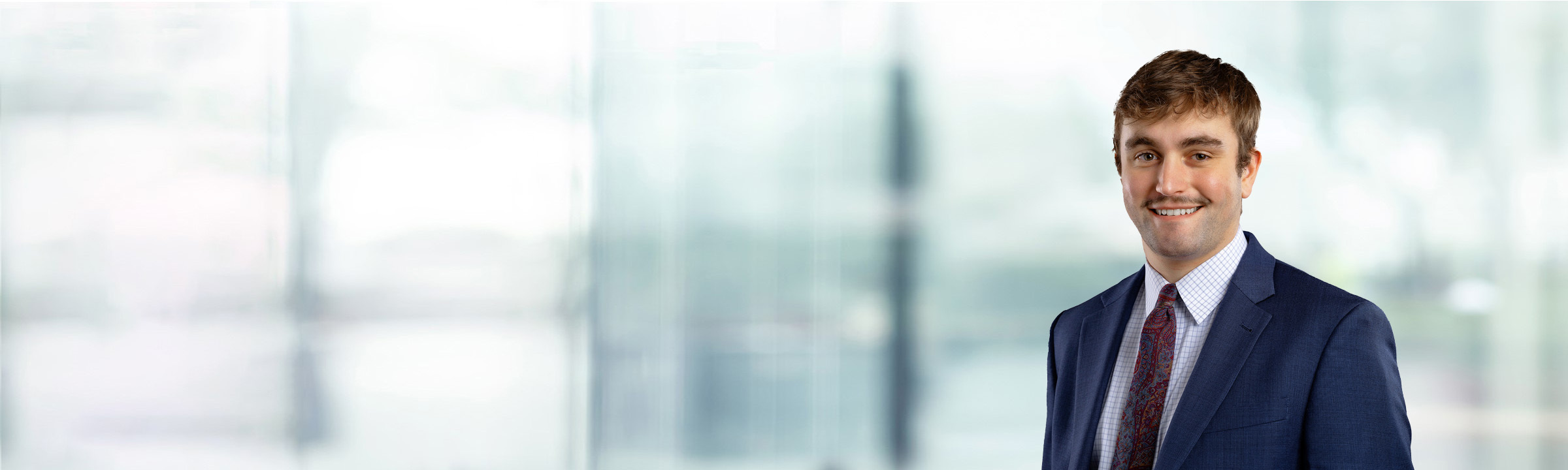 Noah Chase on light blue and white bokeh banner