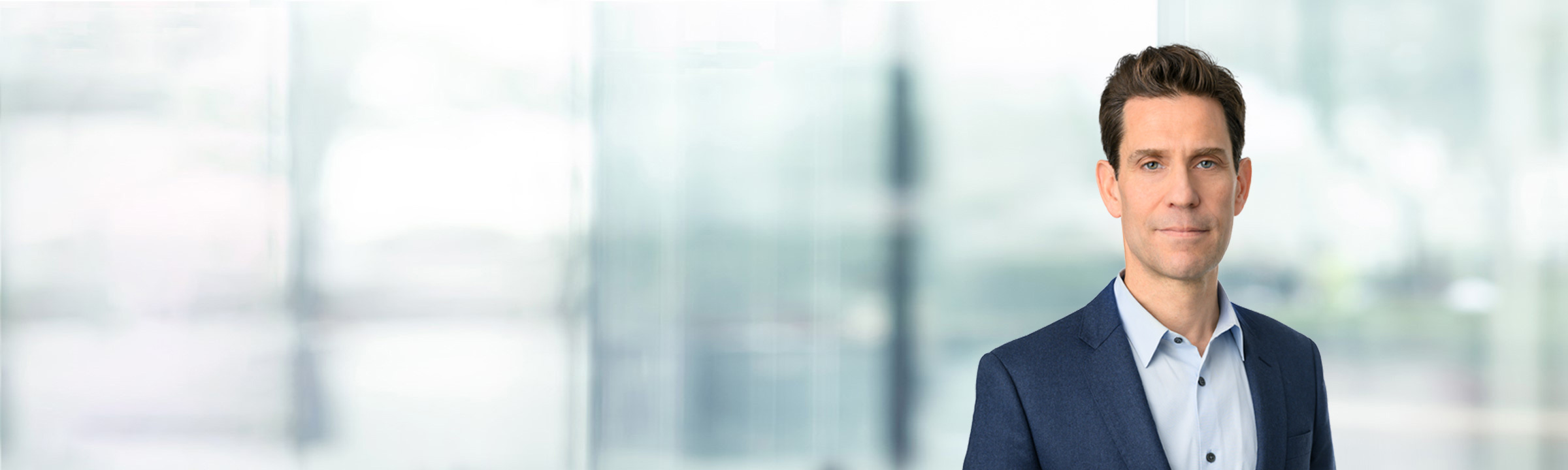 Axel Bernabe on light blue and white bokeh banner