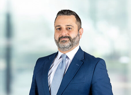 Aaron Saykin on light blue and white bokeh banner