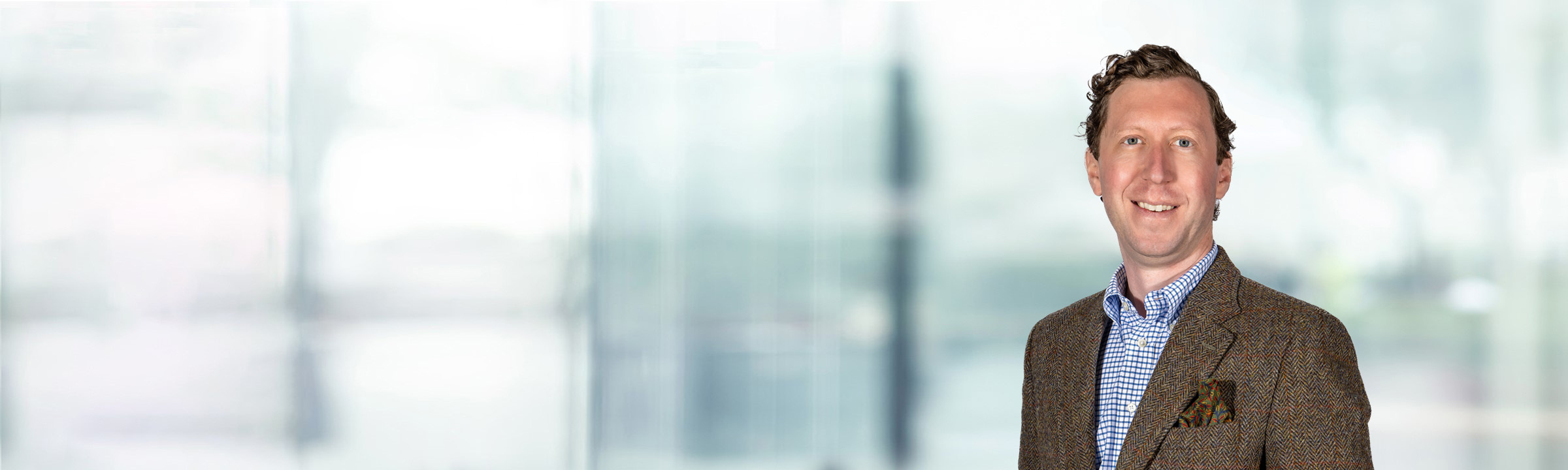 William Ciszewski on light blue and white bokeh banner