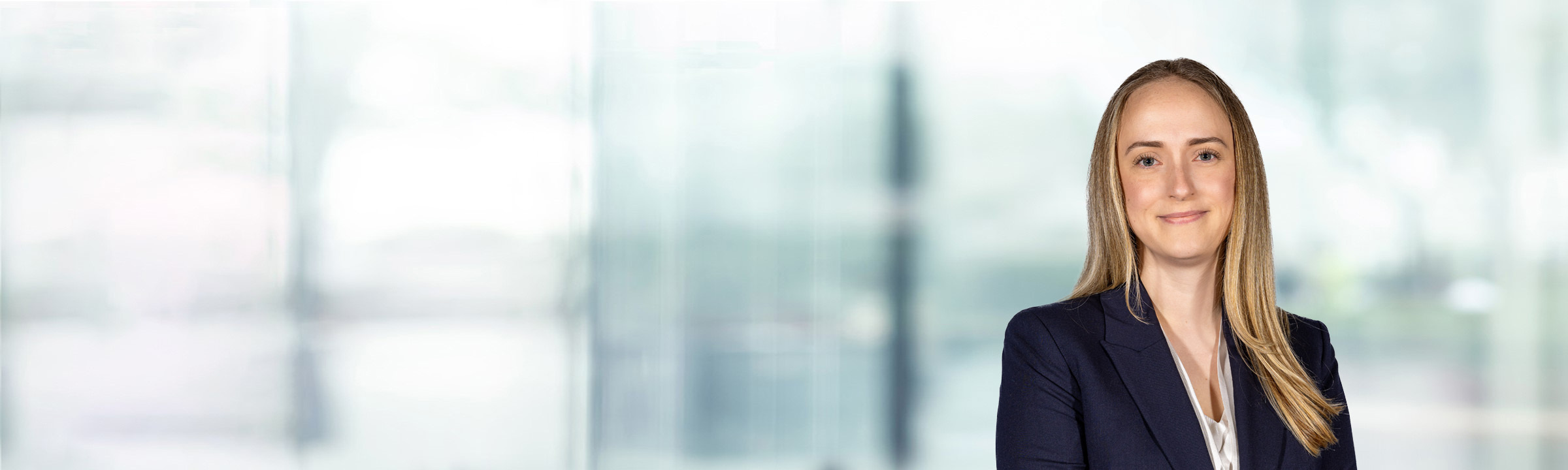 Claire Wells on light blue and white bokeh banner