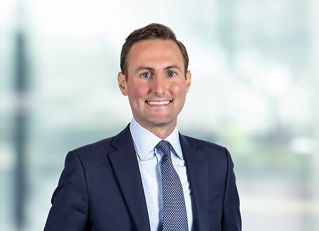 Patrick Owens on light blue and white bokeh banner