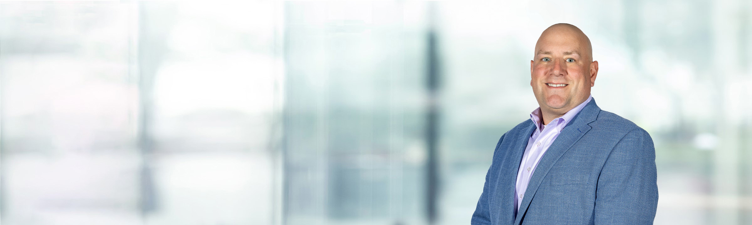 Charles Malcomb on light blue and white bokeh banner