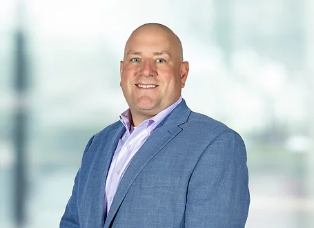 Charles Malcomb on light blue and white bokeh banner