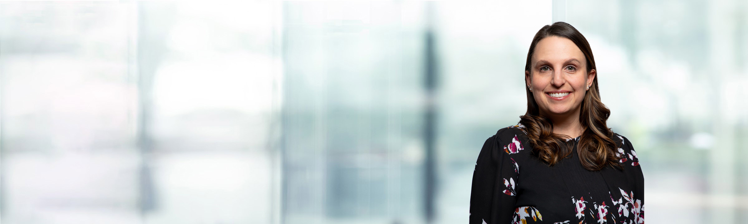 Erin Young on light blue and white bokeh banner