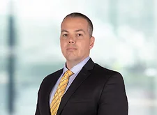 John Godwin on light blue and white bokeh banner