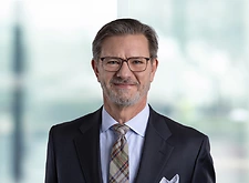 John Zak on light blue and white bokeh banner