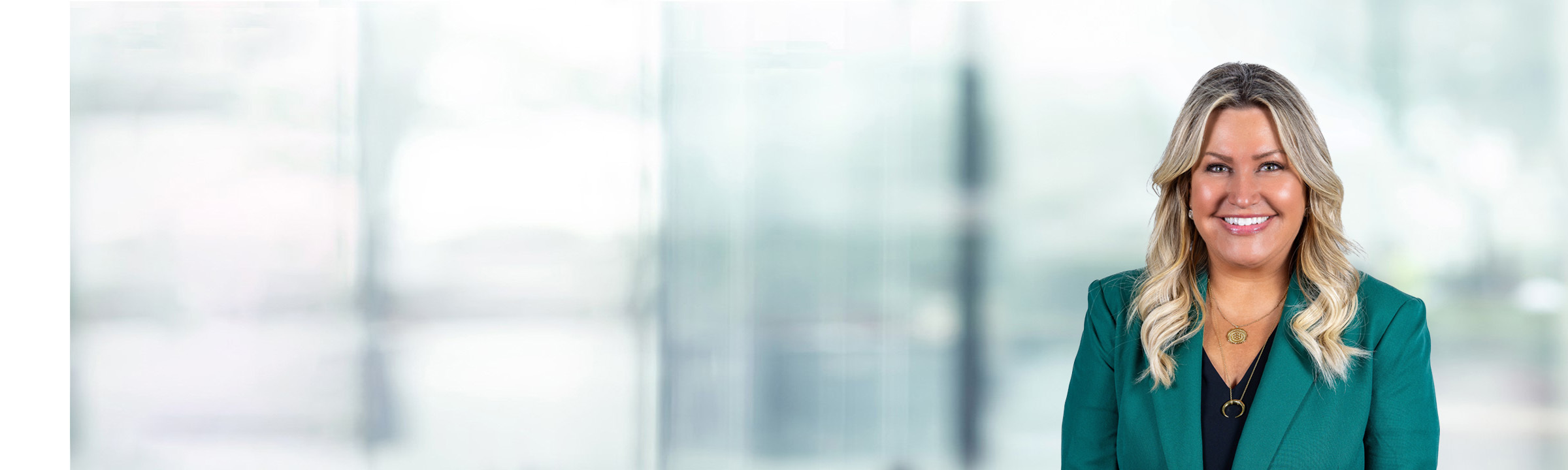 Britta McKenna on light blue and white bokeh banner