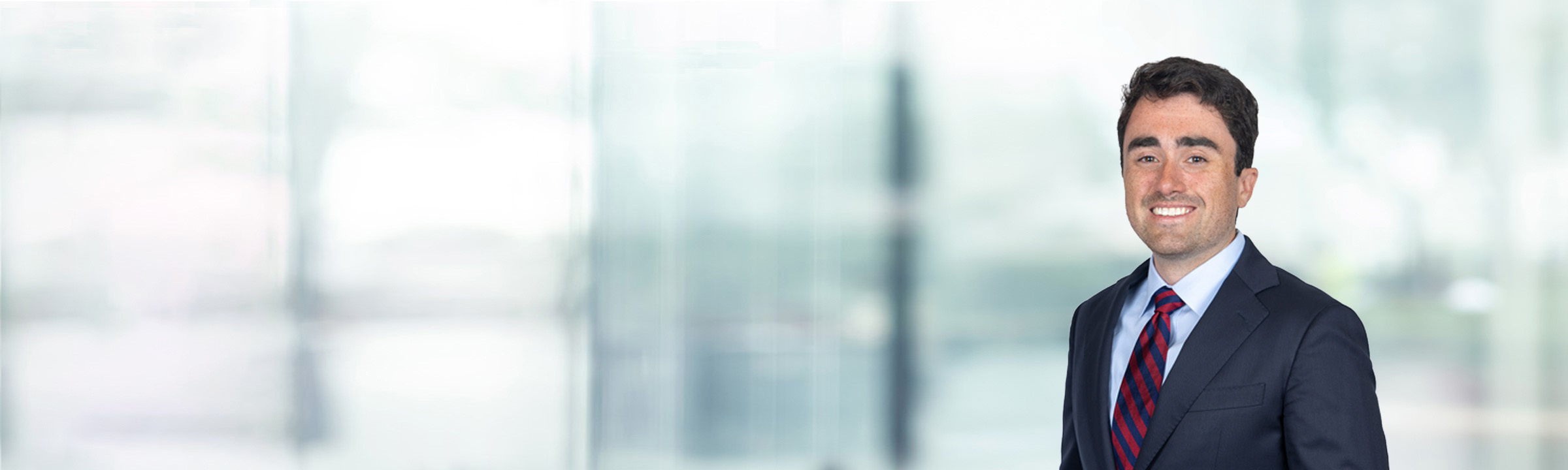 Nicholas Foti on light blue and white bokeh banner