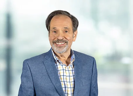 Mark Klein on light blue and white bokeh banner