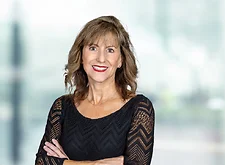 Carol Fitzsimmons on light blue and white bokeh banner