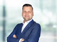 Danijel Augustinovic on light blue and white bokeh banner
