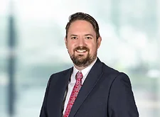 David Wilks on light blue and white bokeh banner