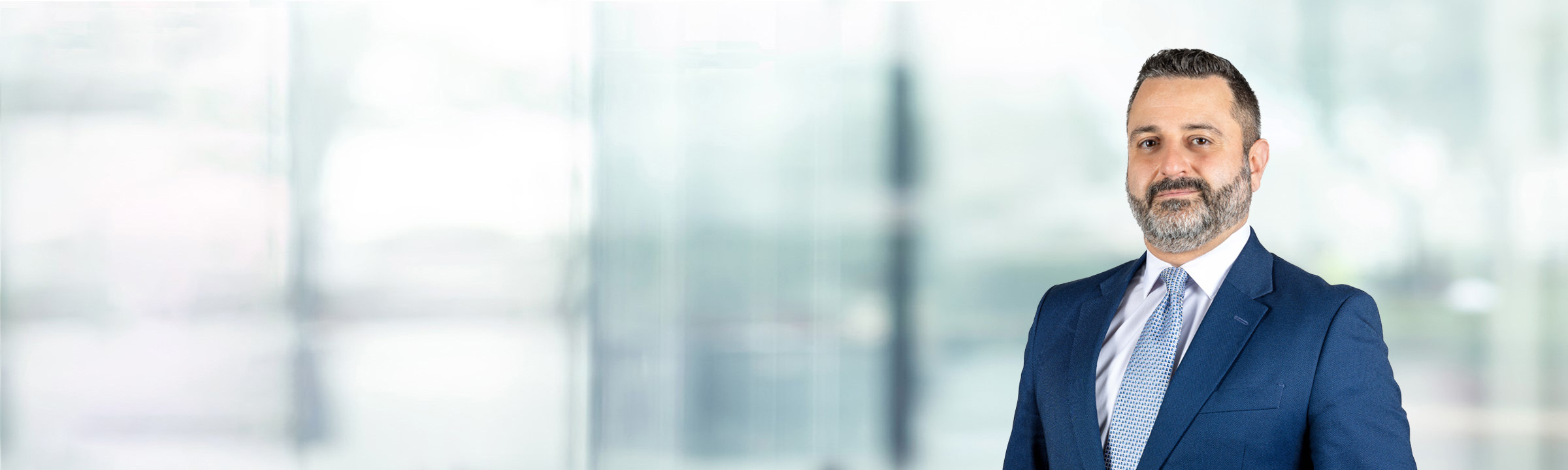 Aaron Saykin on light blue and white bokeh banner